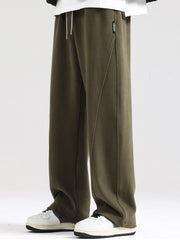Men's army green wide-leg sweatpants with drawstring waist and seam detail.