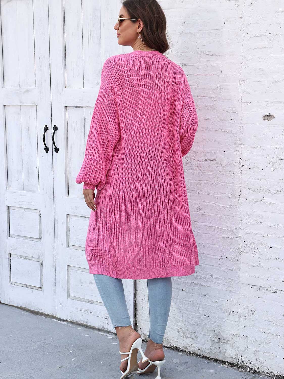 Pink ribbed knit maxi cardigan with pockets and balloon sleeves.
