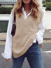 Textured knit vest in cream with V-neck and asymmetric hem, styled over a white shirt.