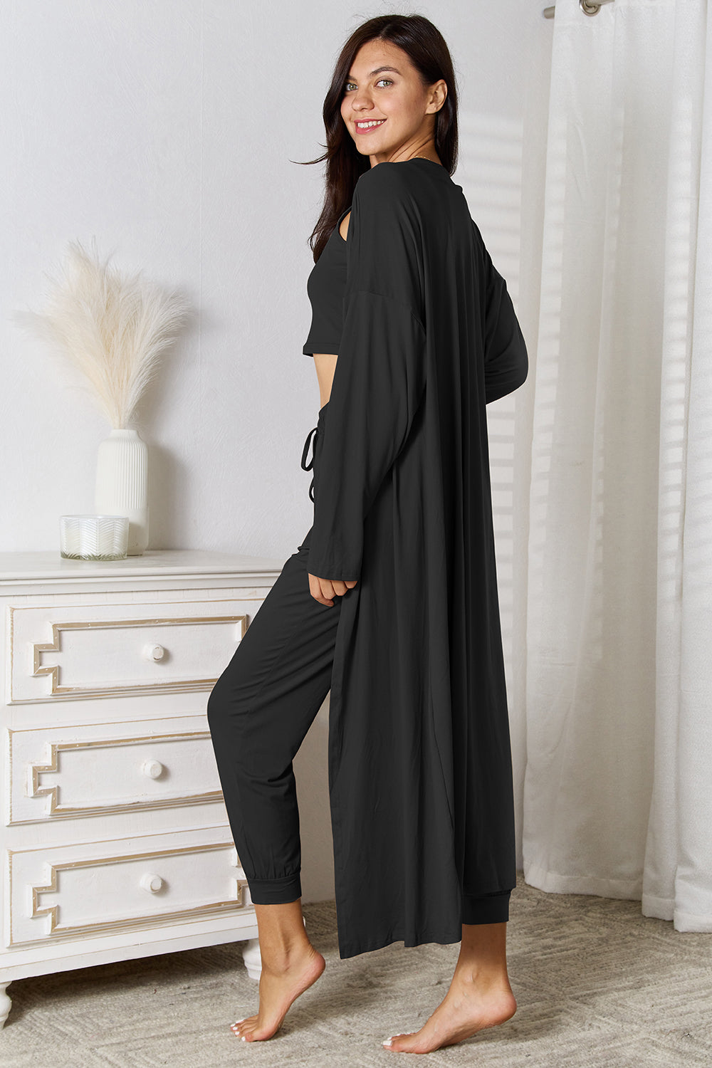 Black loungewear set with long cardigan, crop top, and drawstring pants.