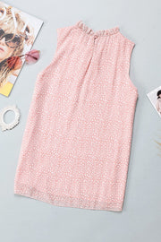 Blush pink sleeveless blouse with ruffled neckline and allover print.