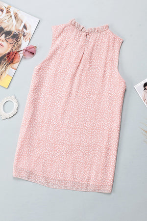 Blush pink sleeveless blouse with ruffled neckline and allover print.