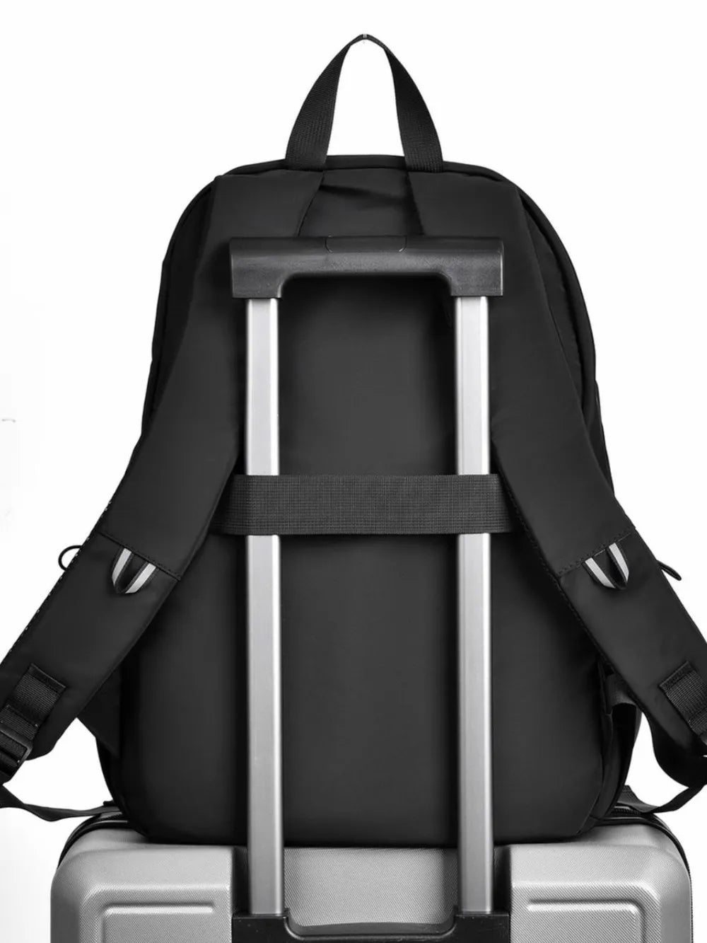 Black urban commuter backpack with luggage strap and trolley sleeve detail