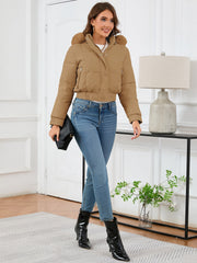 Camel puffer jacket with faux fur trim, cropped length, and zippered pockets.