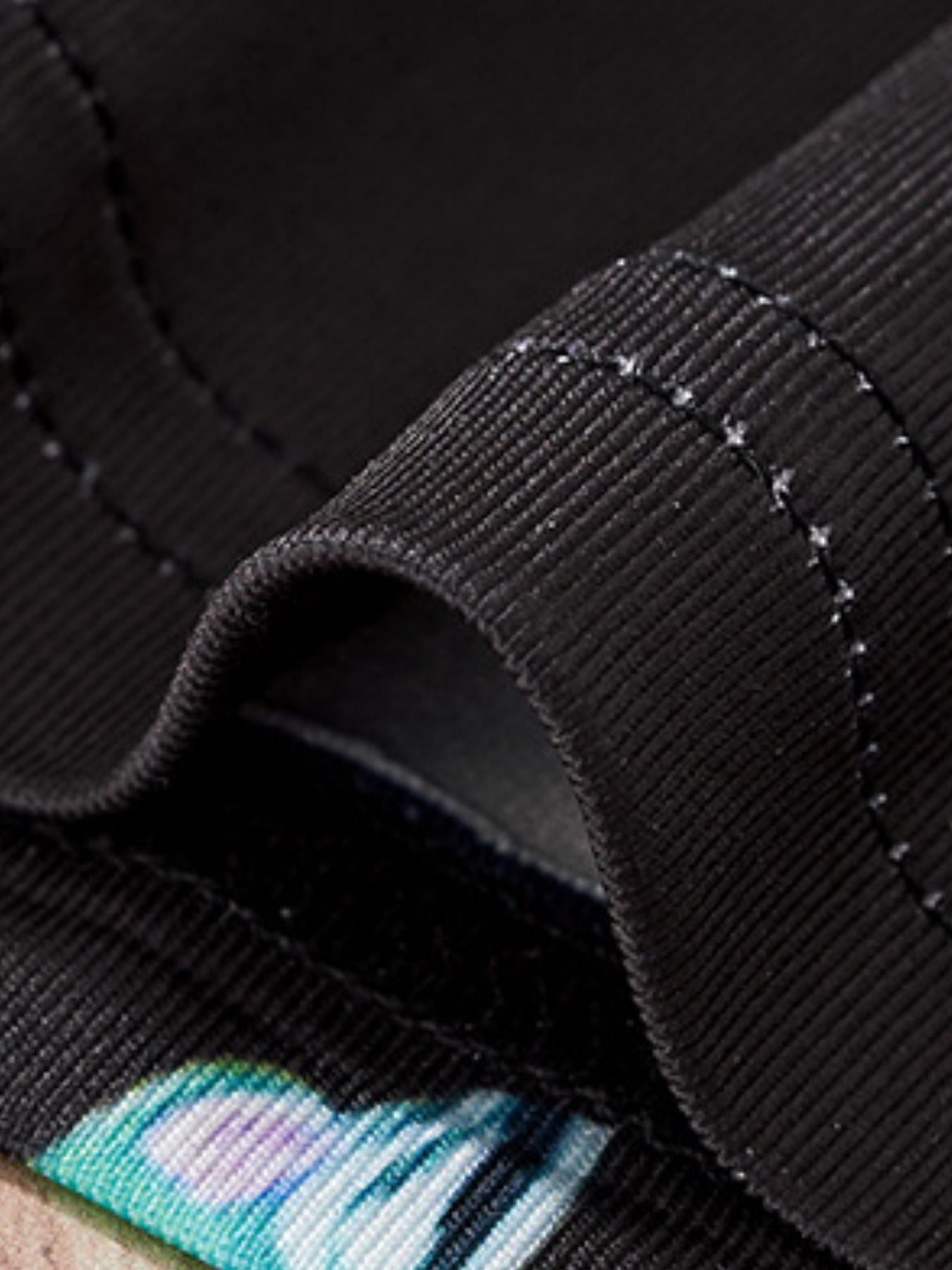 Black toddler two-piece set with colorful dinosaur print detail and ribbed trim.