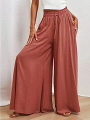 Gathered waist palazzo pants in orange-red with a drawstring and wide legs.