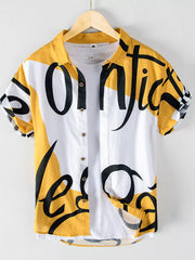 Men's yellow and white abstract script print short sleeve cotton button-up shirt.