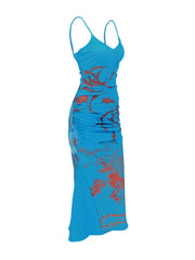 Blue botanical print spaghetti strap maxi dress with ruched side detail.