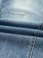 Light wash denim maternity jeans with visible seams and stitching detail.