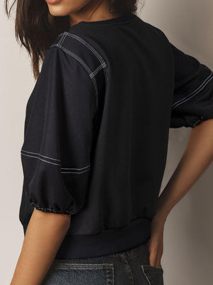 Black blouse with contrast stitching and puff sleeves