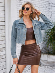 Light blue denim bolero jacket with raw hem and button front, worn by a model.