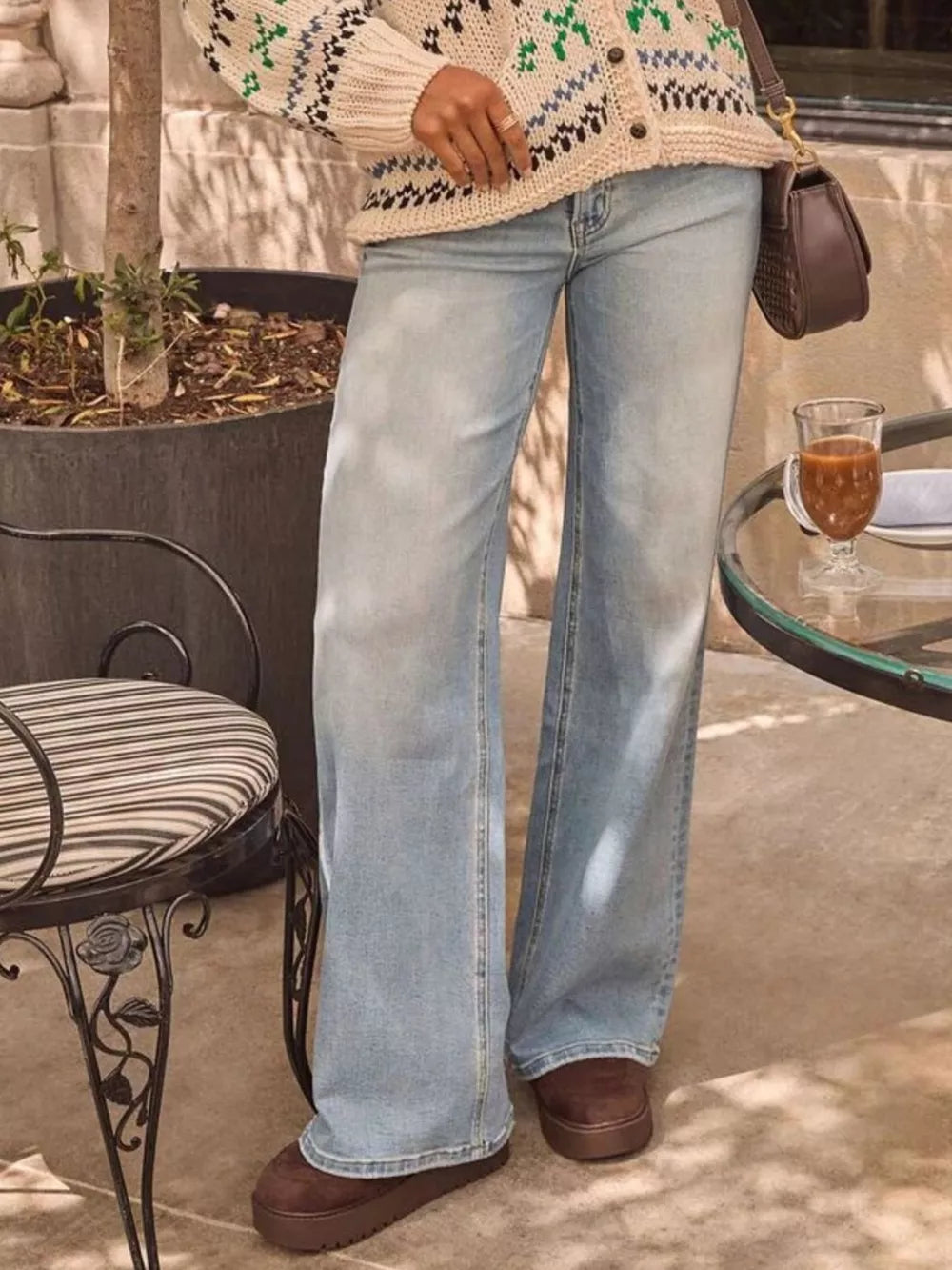 Light blue denim jeans with a relaxed fit and high waist, styled with a cardigan and platform shoes.