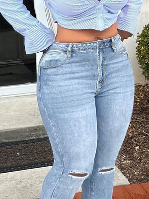 Light blue distressed flare jeans with raw hem and knee rips