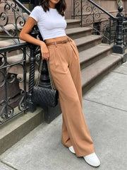 Belted wide-leg pants in camel with front pleats and a brown belt.
