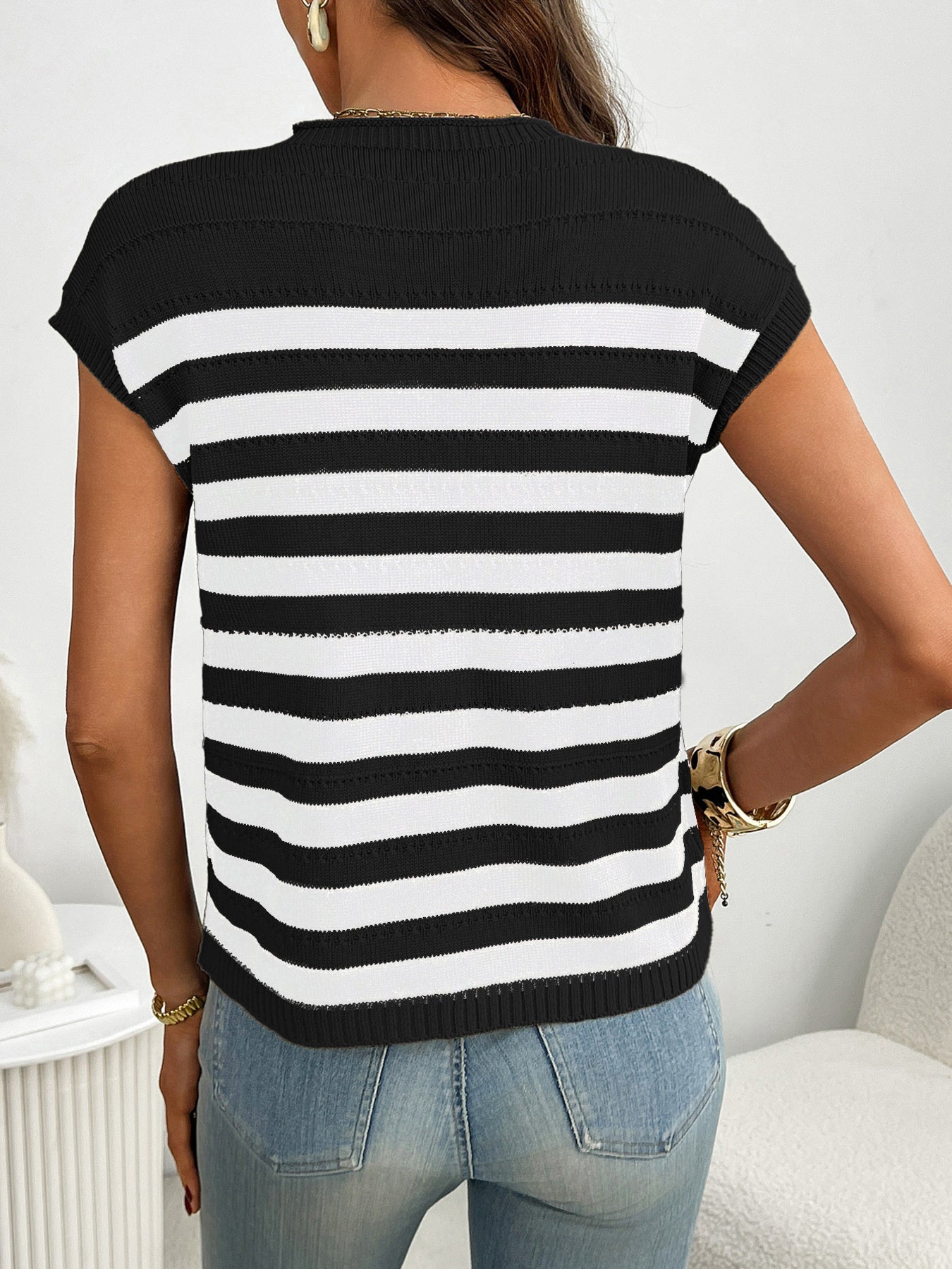 Black and white striped knit sweater with short sleeves and a mock neck.