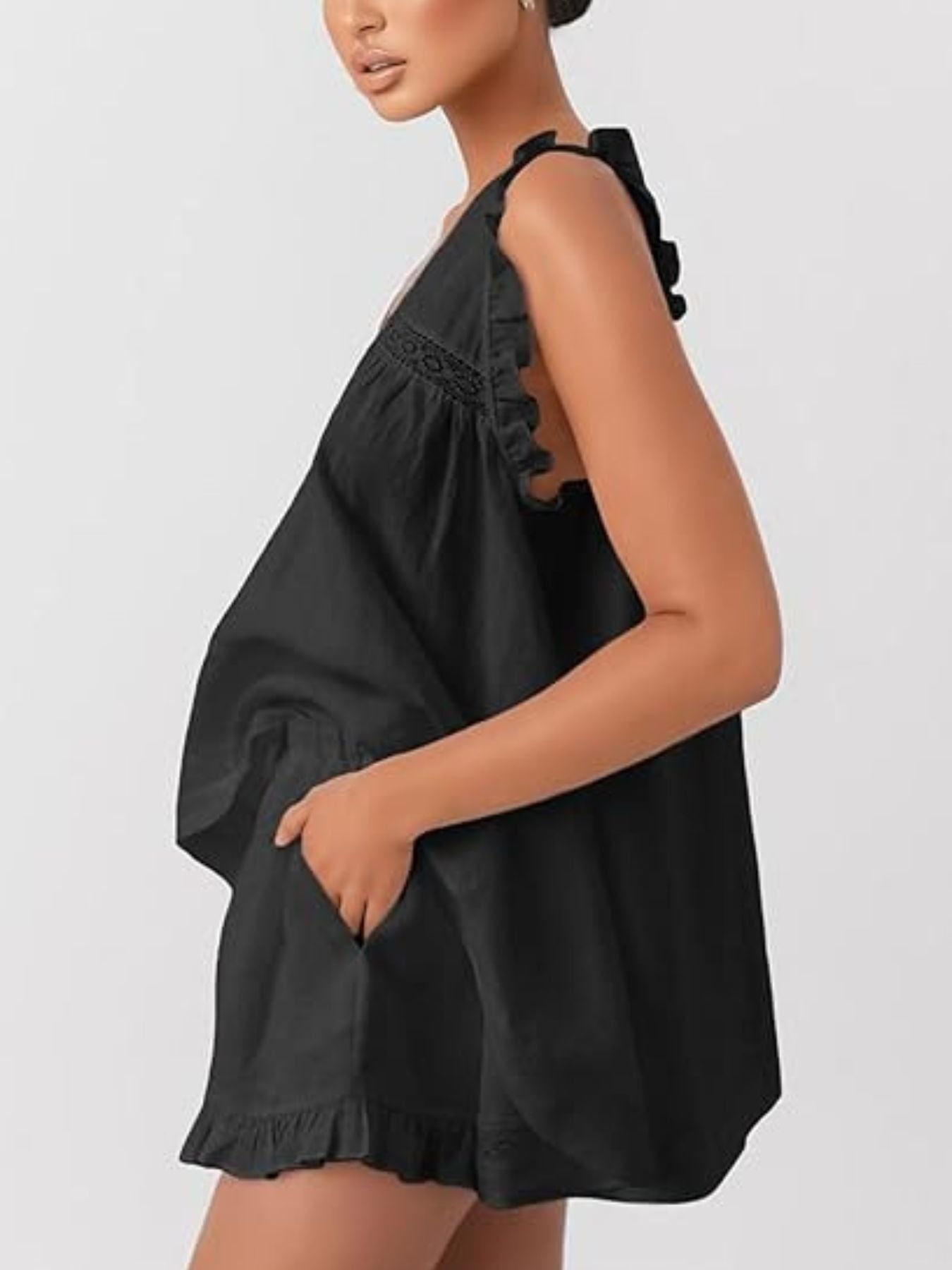 Black ruffled V-neck top and shorts set with lace detail and pockets.