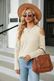 Ivory textured knit cold-shoulder sweater with long sleeves.