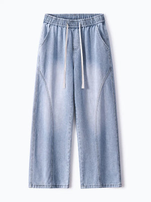 Men's light wash wide-leg jeans with drawstring waist and vintage fade detail.