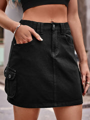 Black denim utility mini skirt with cargo pockets and elastic waistband.
