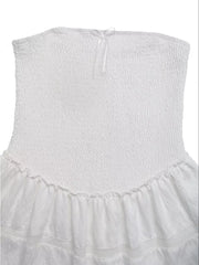 White smocked strapless mini dress with eyelet hem and bow detail