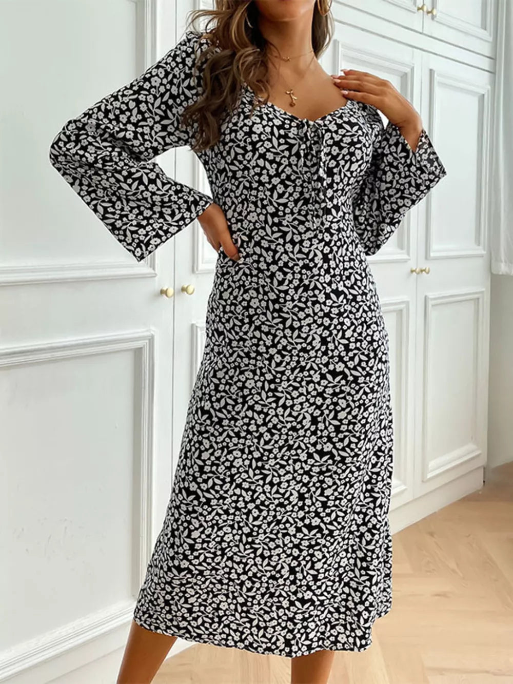 Floral print midi dress with flare sleeves and a tie-neck detail.