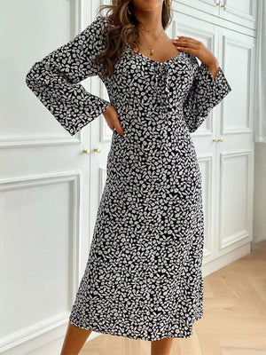 Floral print midi dress with flare sleeves and a tie-neck detail.