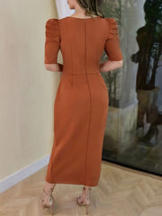 Orange cotton bodycon midi dress with puff sleeves and a back zipper.