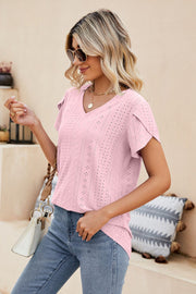 Blush pink knit top with perforated details and flutter sleeves.