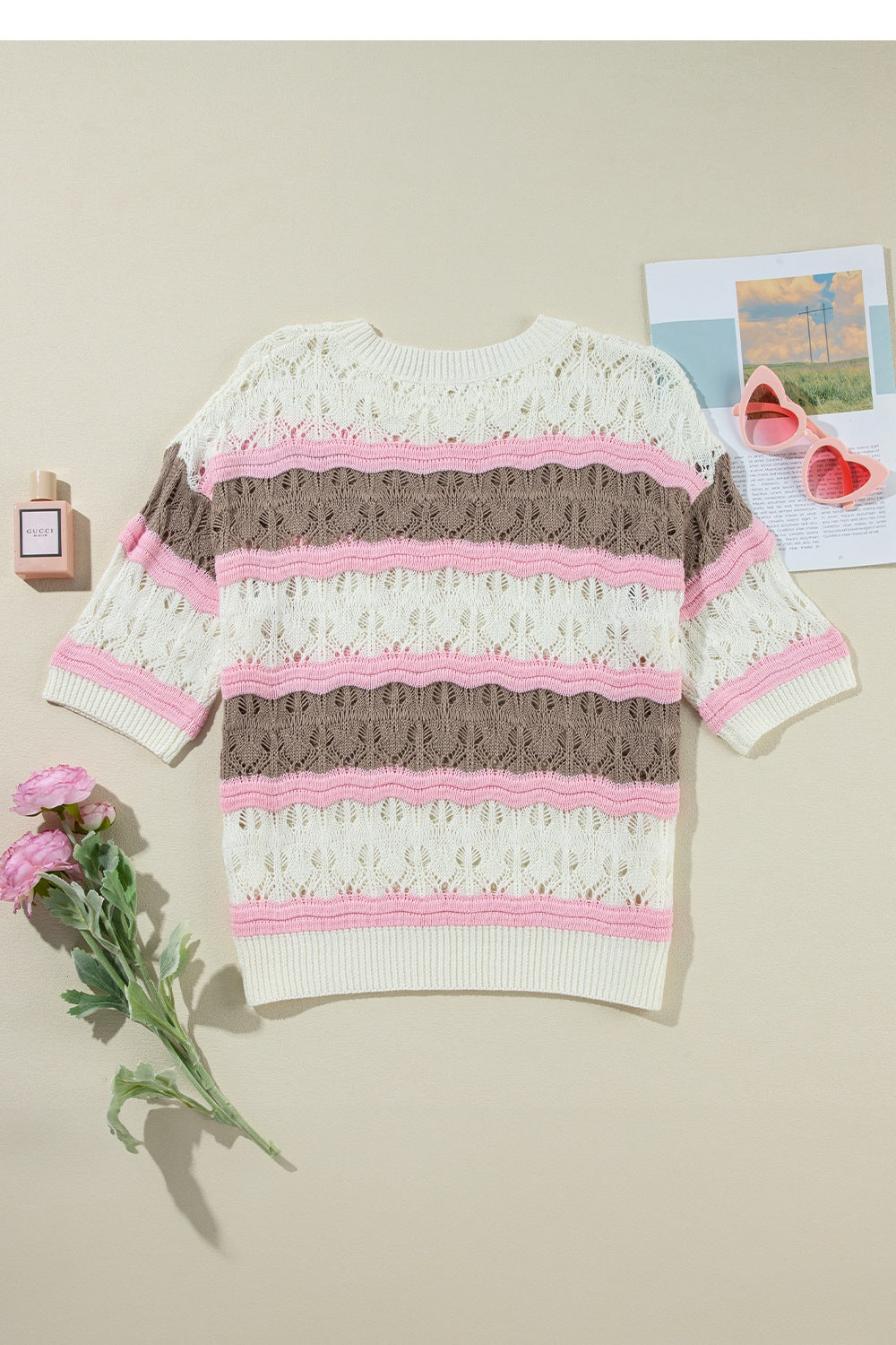 Striped openwork knit top with short sleeves in cream, taupe, and pink.