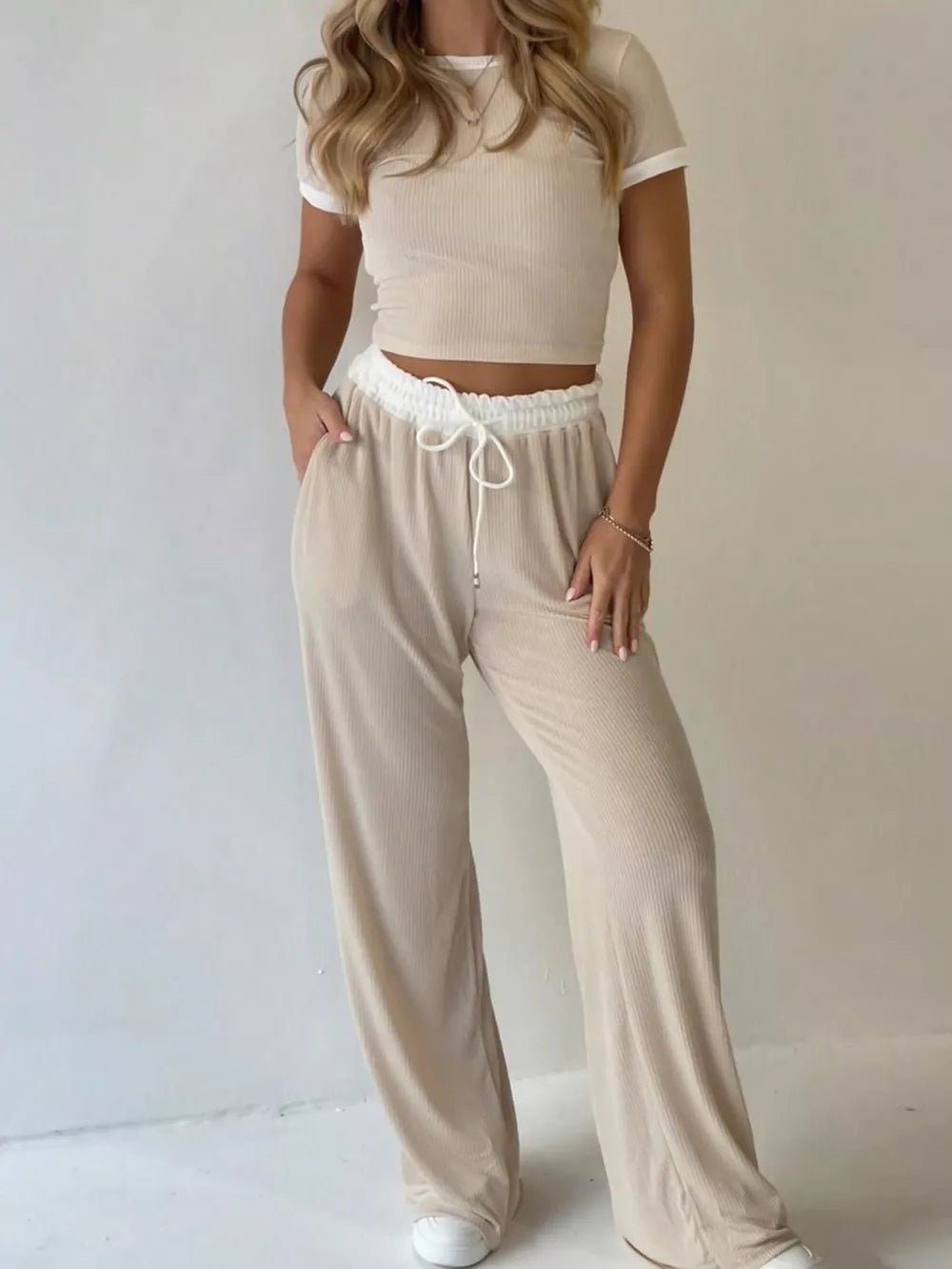 Ribbed crop top and wide-leg pants set with contrast trim and drawstring waist.