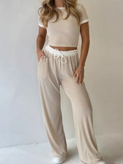 Ribbed crop top and wide-leg pants set with contrast trim and drawstring waist.