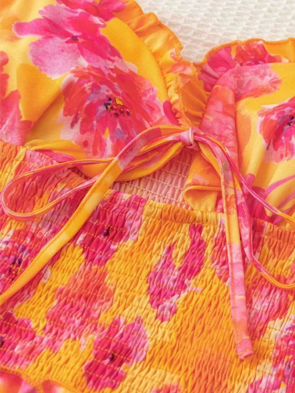 Yellow floral print mini dress with smocked bodice and tie detail