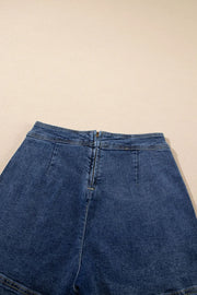 Denim wrap skort in medium wash with zipper closure and patch pockets.
