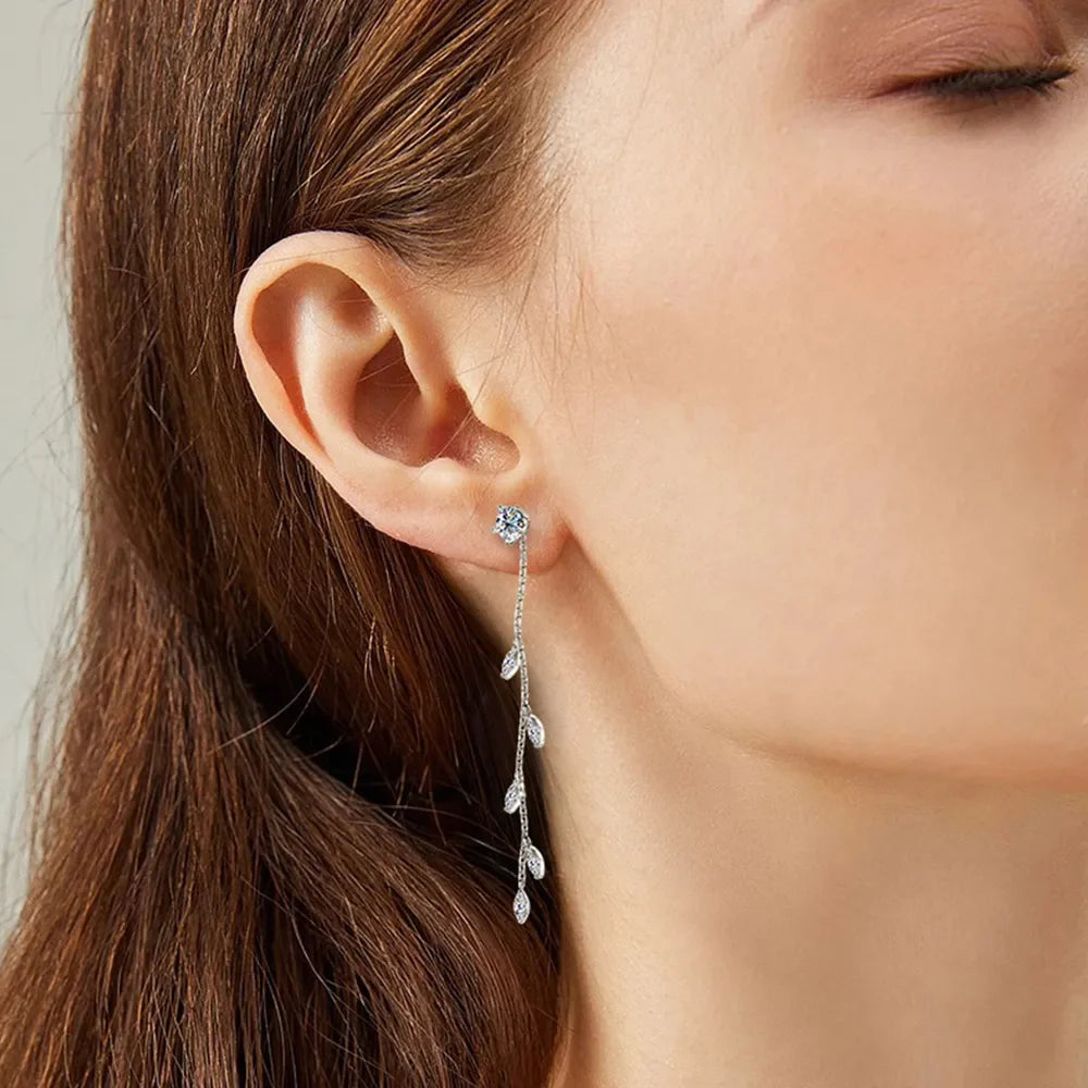 Dangling crystal vine earrings in silver with delicate leaf accents.