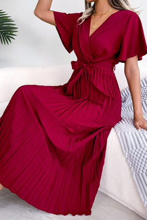 Red wrap bodice midi dress with flutter sleeves and pleated skirt.