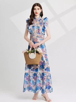 Maxi dress with floral lace cutout details in blue and purple, featuring ruffled sleeves and a high neckline.