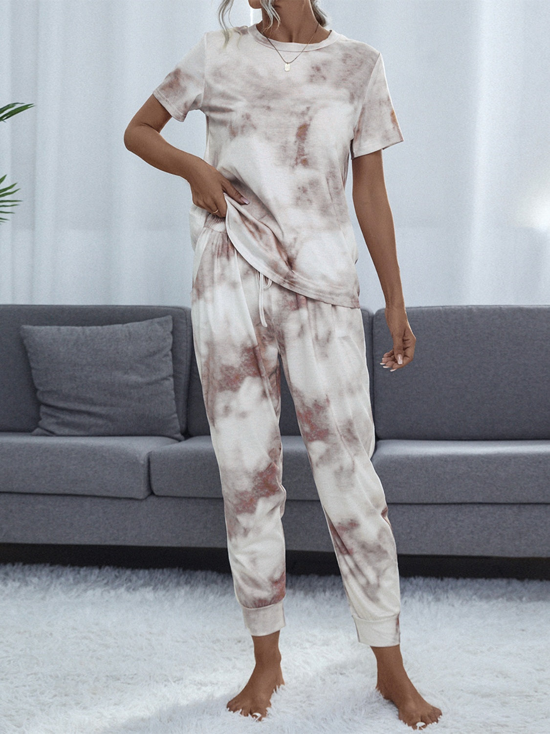 Multicolor tie-dye loungewear set with short sleeve top and drawstring pants.