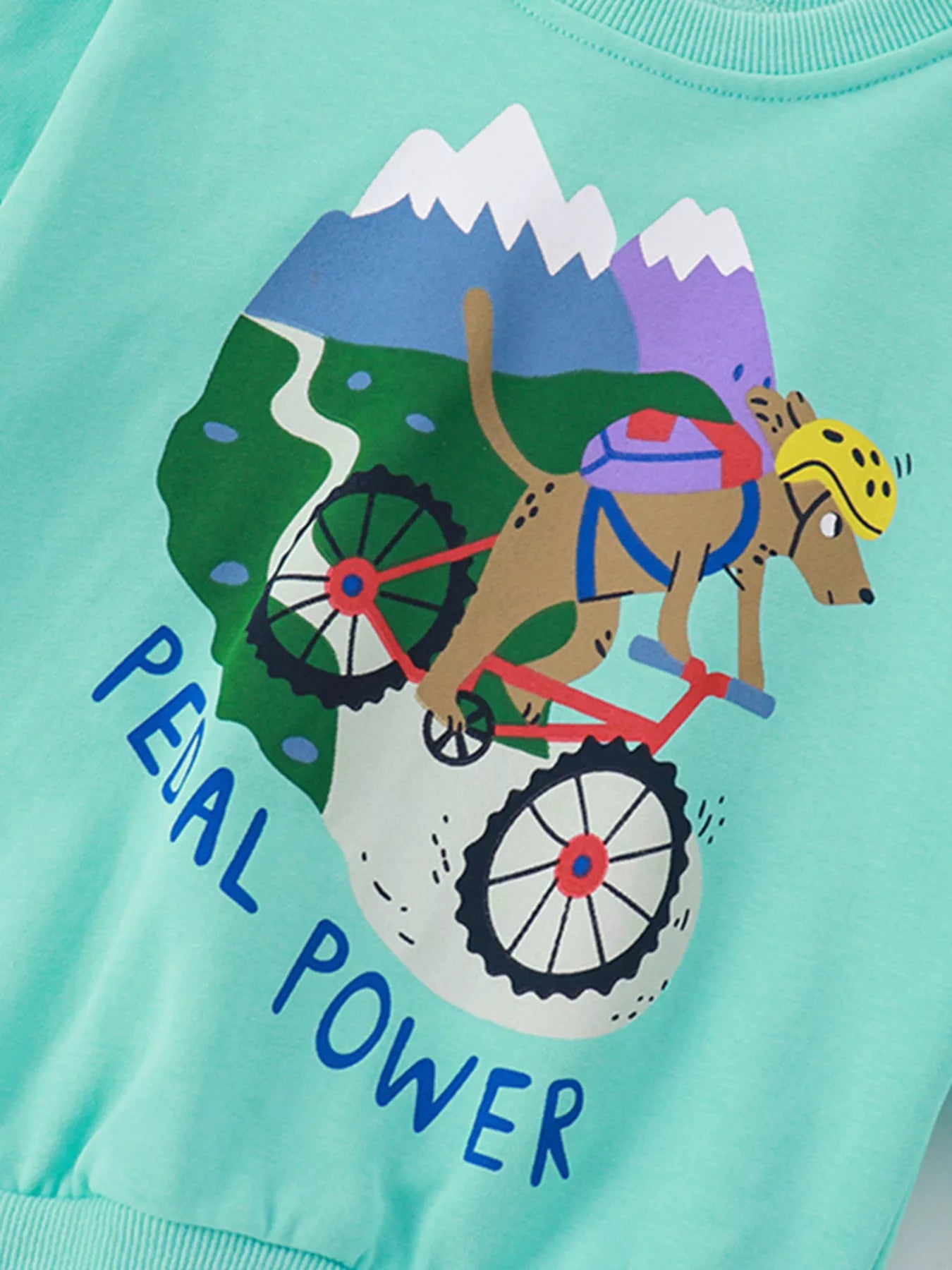 Mint blue kids' sweatshirt with a graphic of a dog biking downhill with mountains and "Pedal Power" text.