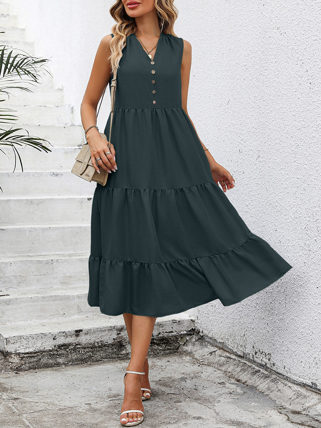 Dark green sleeveless midi dress with button-down front and tiered ruffles.