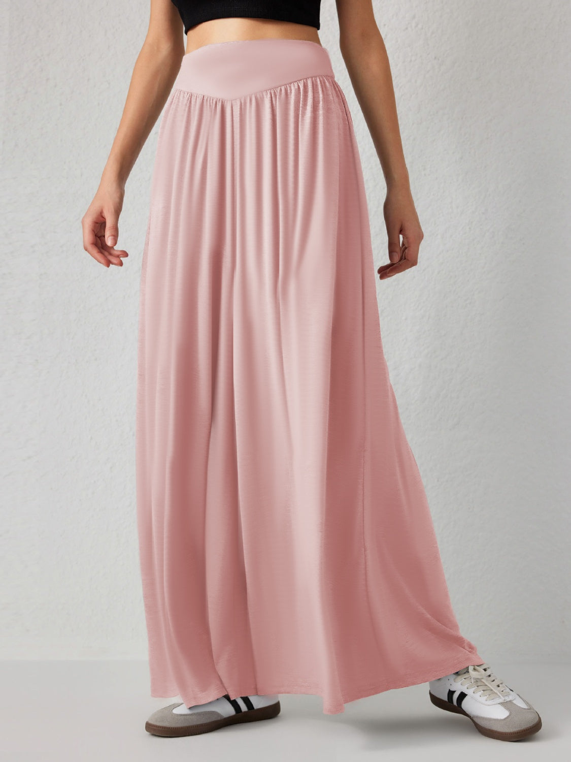 Drape-front wide-leg jersey trousers in a soft pink, featuring a high elasticated waistband and flowing silhouette.