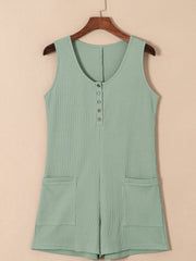 Sage green waffle knit button-down romper with pockets and a scoop neckline.