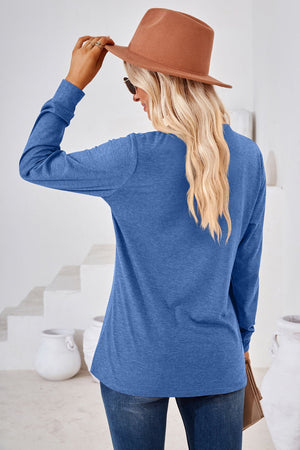 Blue long sleeve jersey top with henley neckline