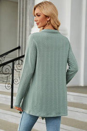 Light Green textured knit cardigan with asymmetrical hem and long sleeves.