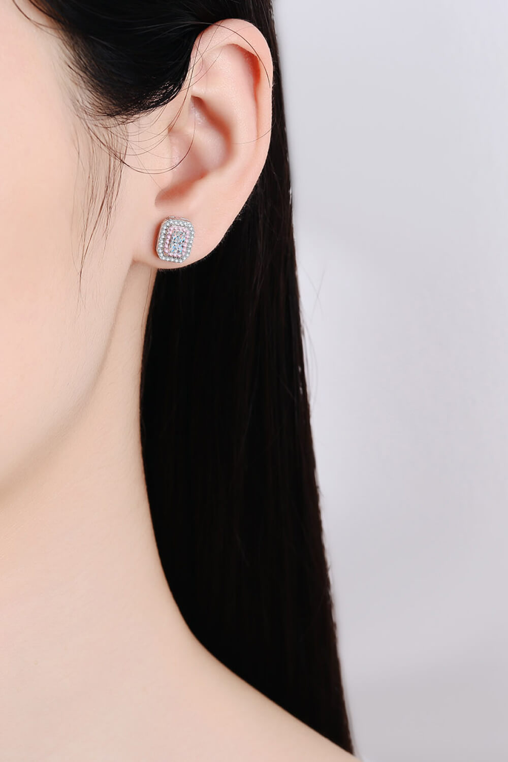 Radiant Emerald-Cut Halo Studs in silver with pink and blue accents.
