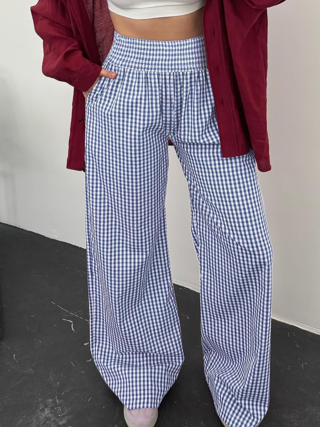 Blue gingham smocked high-waist wide-leg pants with pockets.