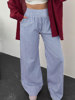 Blue gingham smocked high-waist wide-leg pants with pockets.