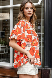 Floral print blouse with flutter sleeves and lace trim neckline in caramel.
