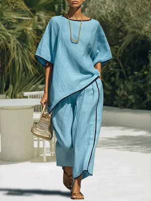 Sky blue two-piece set with contrast trim, half sleeves, and wide-leg pants.