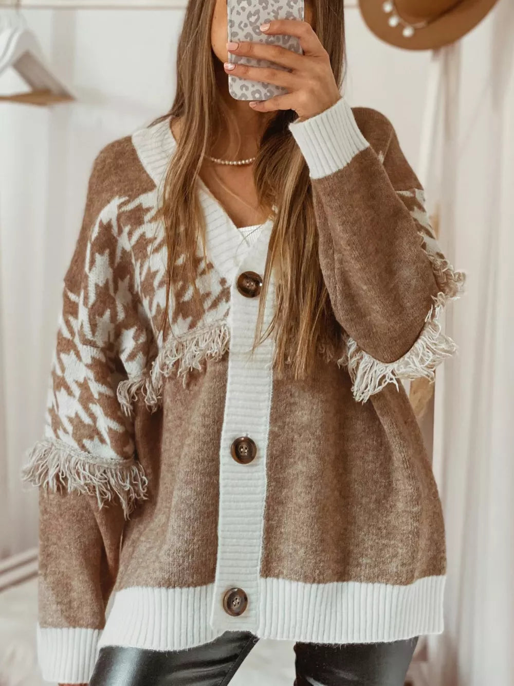 Brown acrylic houndstooth cardigan with white trim and fringe details.