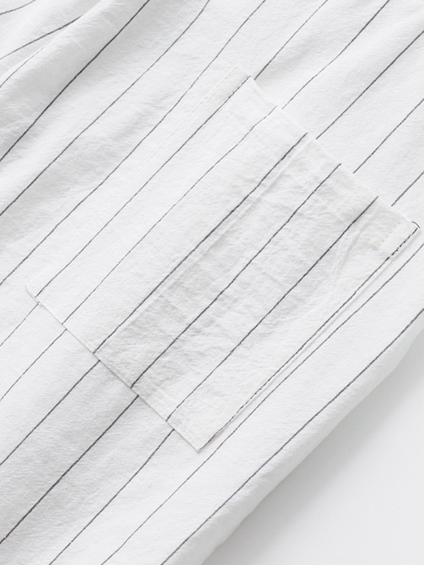 White striped sweatpants with a pocket detail.